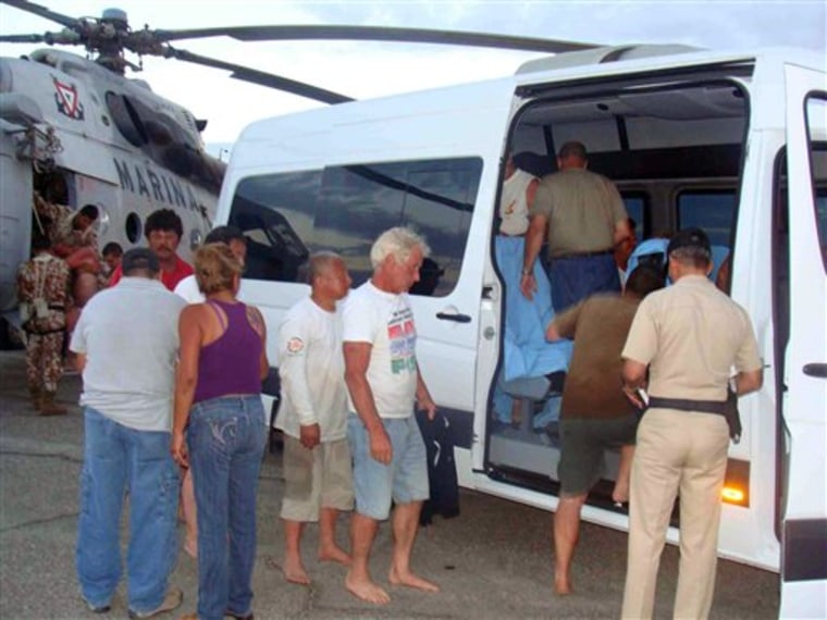 In this image released by the Mexican Navy on Monday July 4, 2011, survivors of a capsized boat are taken away in a vehicle after being rescued by the Navy  in the town of San Felipe, Mexico Monday July 4, 2011. A U.S. tourist died after a fishing boat capsized in an unexpected storm in the Gulf of California off the Baja California peninsula and of the 44 people on the boat, seven U.S. tourists remain missing along with one Mexican crew member, the Mexican Navy said. (AP Photo/SEMAR)